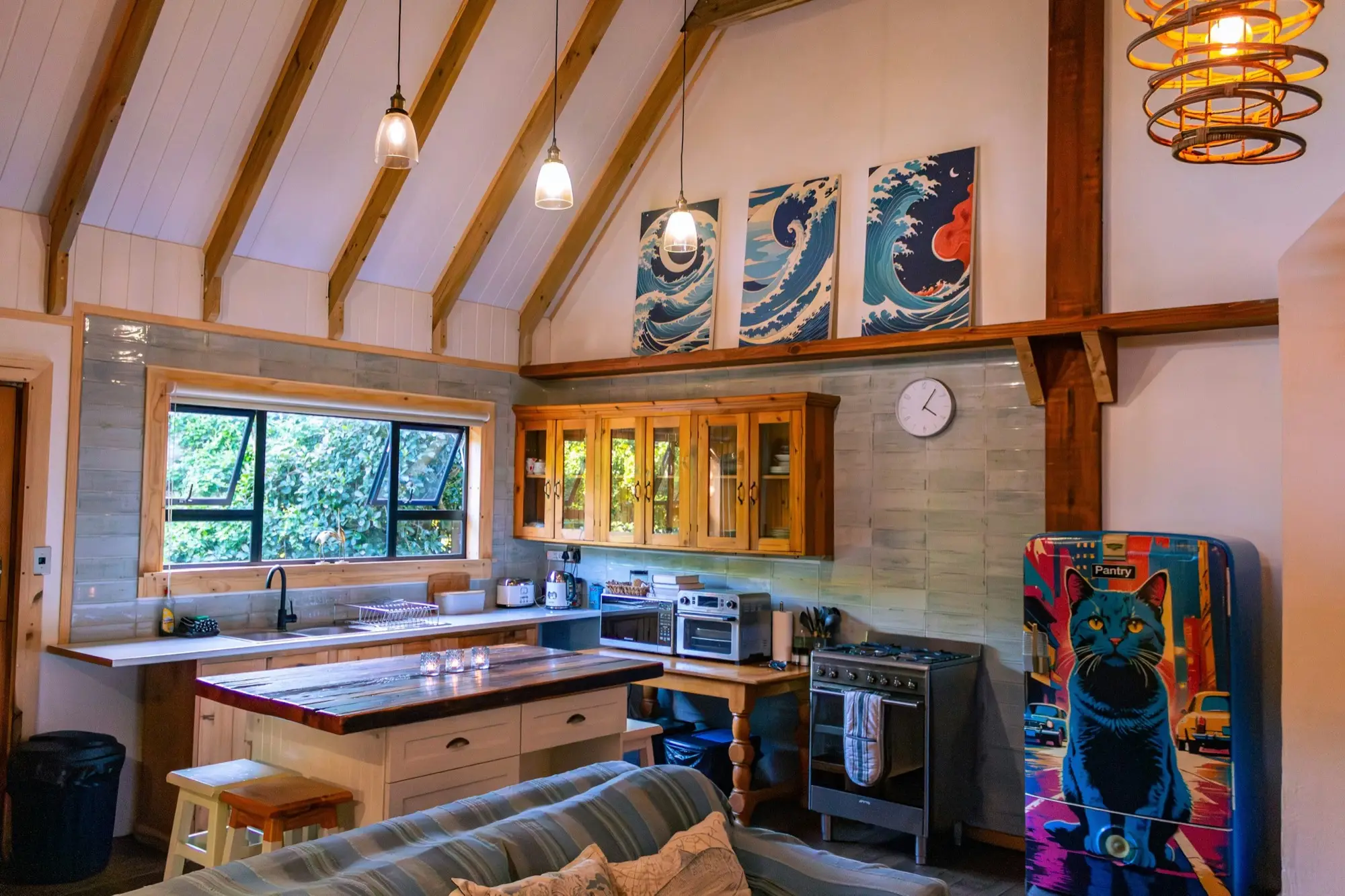 Kitchen with a reclaimed-timber island, gas stove and vaulted timber ceiling