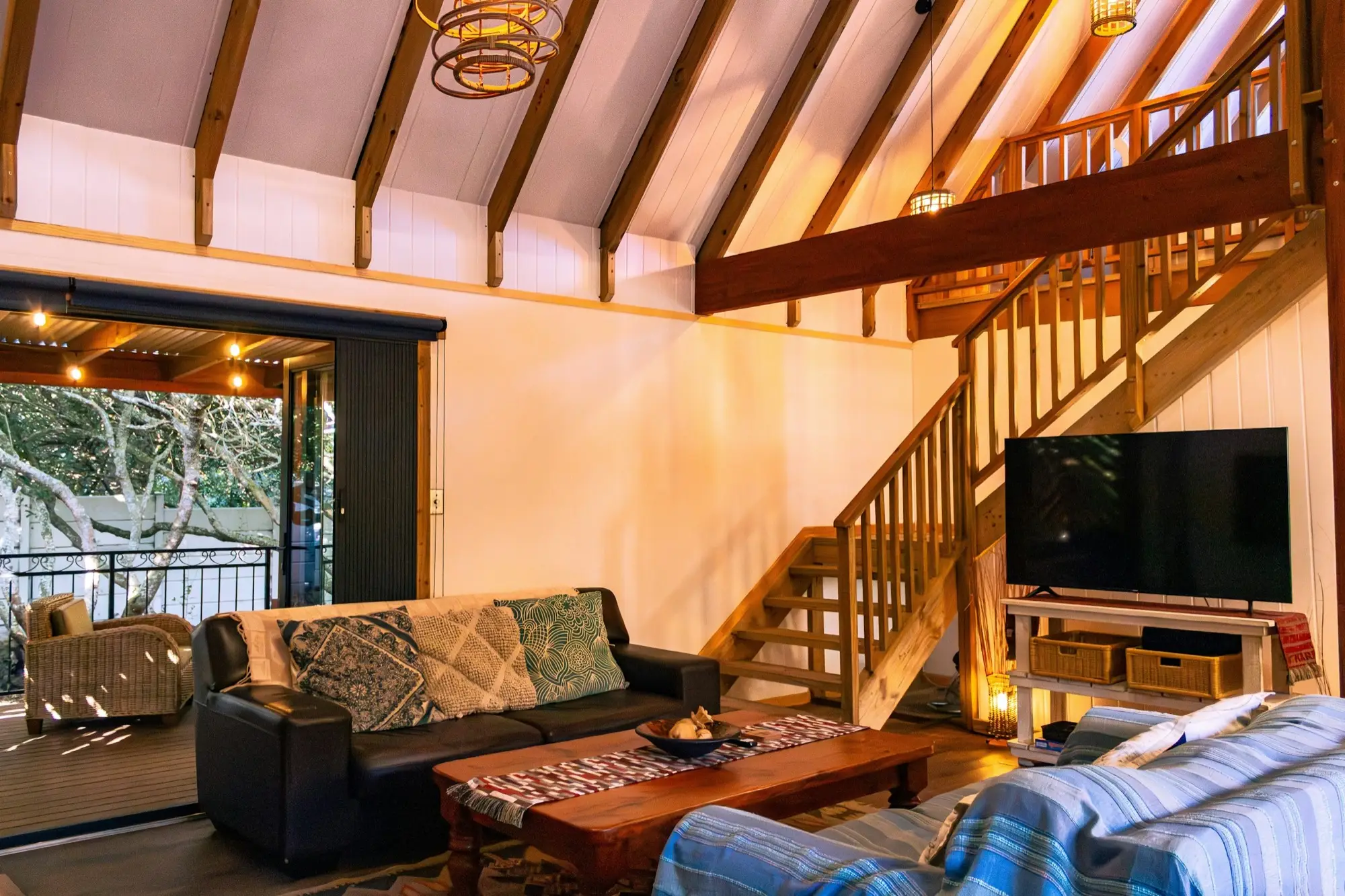 The living room from the doorway, with sofas, a coffee table and the loft above