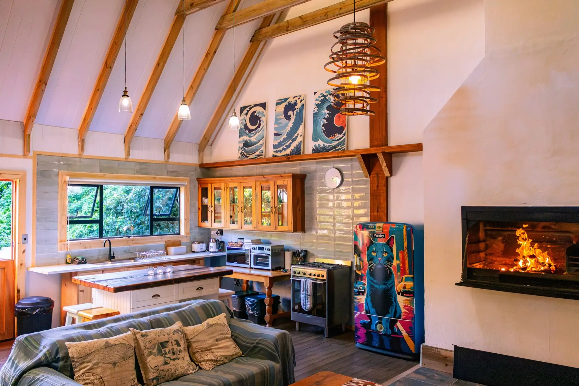 Kitchen and fireplace seen together across the open-plan ground floor