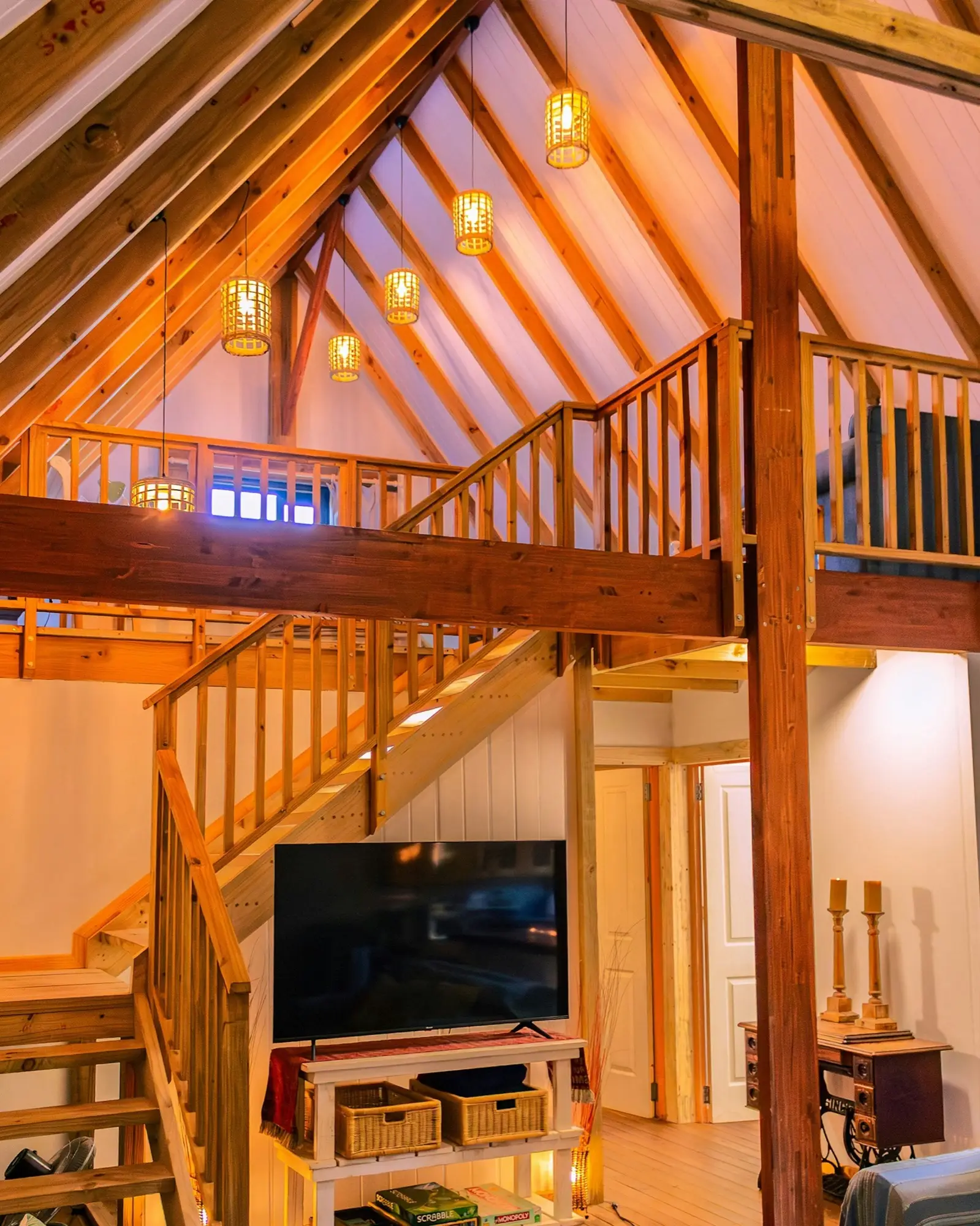 Looking up the timber staircase to the loft and the A-frame roof