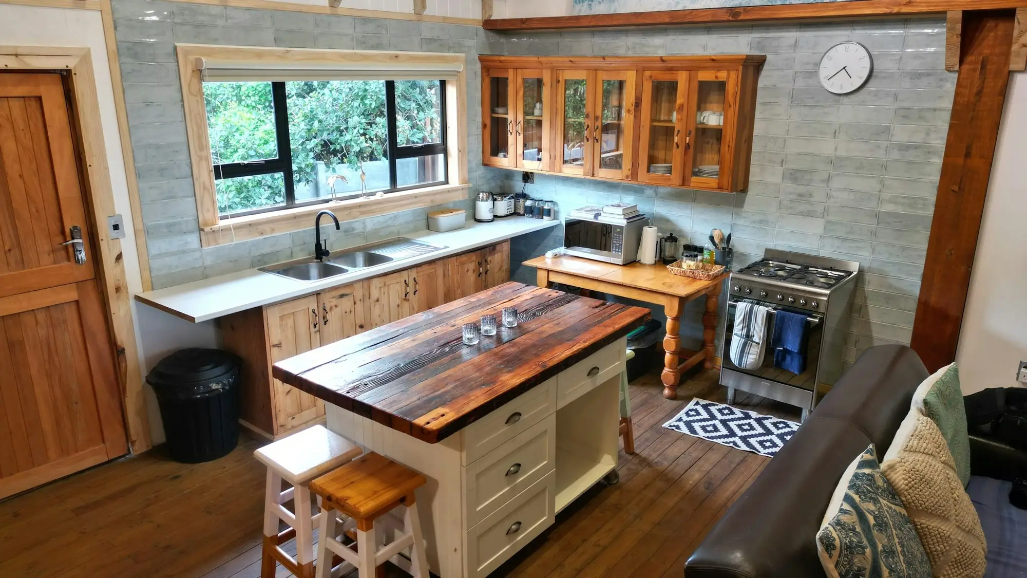 Kitchen seen from the sofa, with the island and gas range